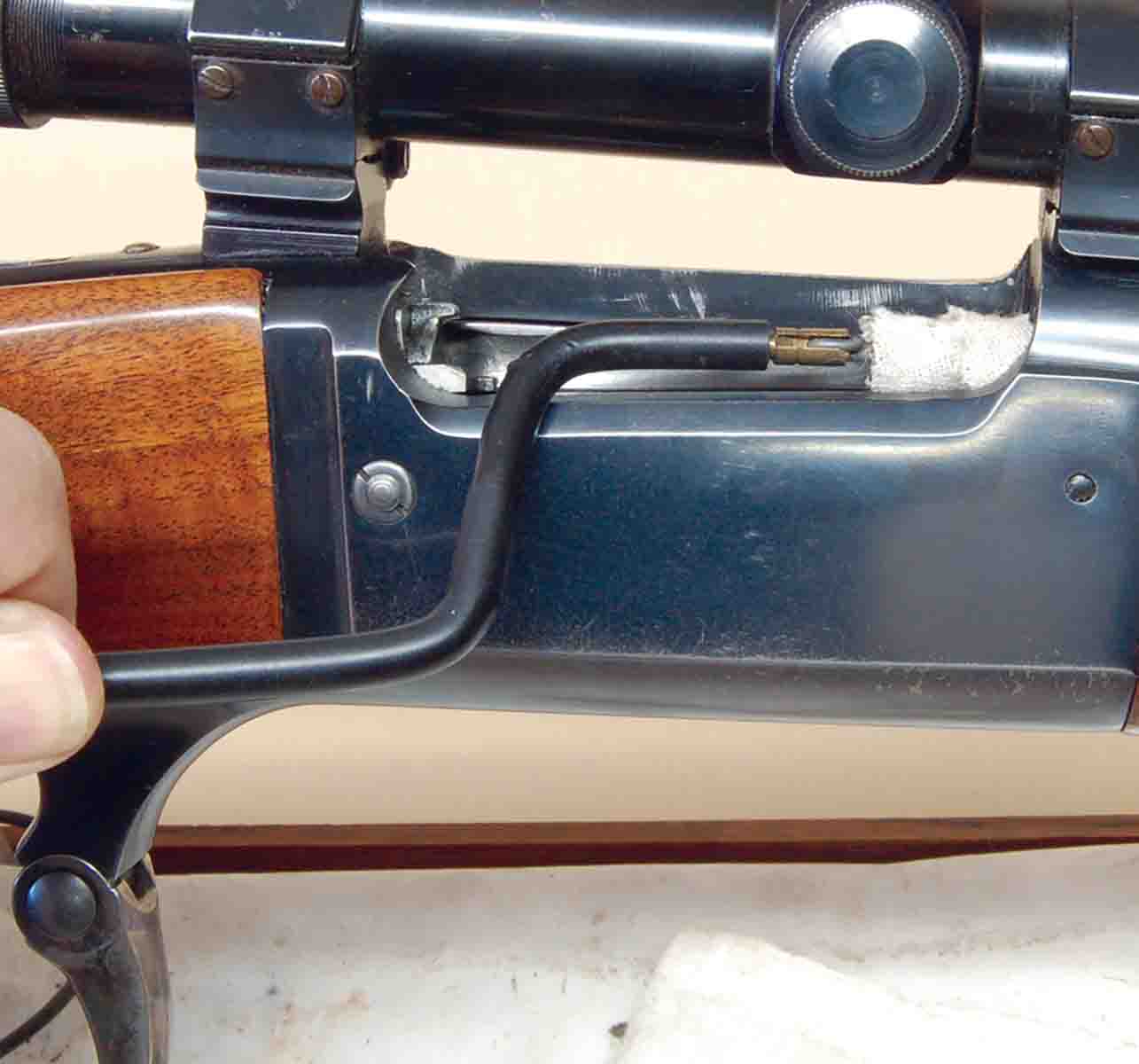 Chamber cleaning and lubing of solid-frame guns is easily done using a bent acetal rod fitted with a bronze brush and patch.